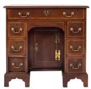 A George III mahogany later satinwood crossbanded and inlaid kneehole desk:,
