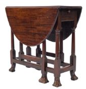 An early 18th Century walnut gateleg table:, of small size, with an oval hinged top,