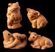 Four Japanese carved boxwood netsukes: of various animals including calf, piglet,