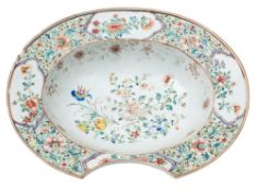 A Chinese famille rose barber's bowl: the centre painted with peaches and flowering plants,