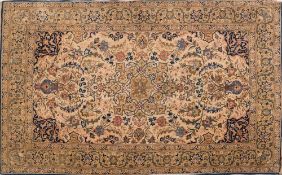 A Tabriz rug:, the beige cartouche field with a central light brown geometric pole medallion,