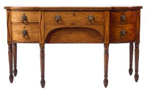 A Regency mahogany and inlaid sideboard: of bowed and breakfront outline, bordered with lines,