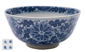 A Chinese blue and white porcelain bowl: the exterior painted with peony and chrysanthemum amongst