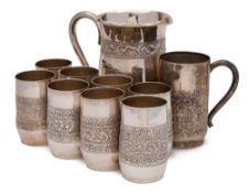 An Indian silver nine-piece cordial set: with banded embossed foliate decoration includes jug and