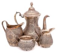 An Indo- Persian three- piece silver tea service: of baluster form with engraved foliate decoration,