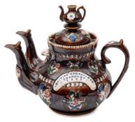 A Measham 'bargeware' double spouted teapot: with domed cover and teapot knop,