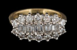 An 18ct gold and diamond cluster ring: with central row of graduated, baguette-cut diamonds,