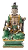 A Chinese sancai-glazed figure of a diety: seated in dhyanasana with the right hand reaching