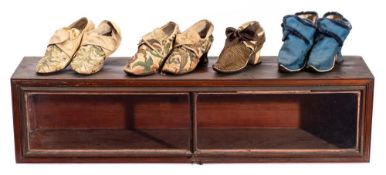 Two pairs of late 17th century shoes: with raised foliate embroidered floral decoration,