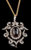 A 19th century carbuncle garnet and diamond open work pendant/brooch: the central,