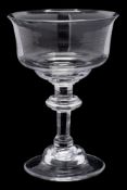 An English sweetmeat glass: the mildly flaring ogee shaped bowl set on a inverted baluster stem