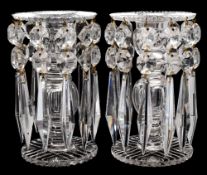 A pair of cut glass table lustres: with circular cut bases supporting a hollow stem with facet cut