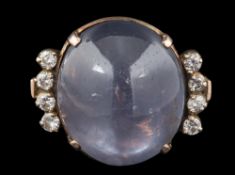 A star sapphire and diamond dress ring: the oval bluish/grey star sapphire approximately 17mm long