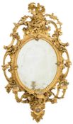 A 19th Century carved giltwood and gesso oval girandole mirror:,