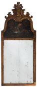 A carved walnut, partly gilt and decorated wall mirror in the early 18th Century taste:,