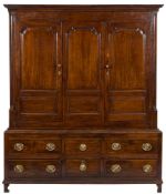 An 18th Century oak livery cupboard:, the upper part with a moulded cornice,