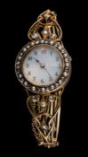 A lady's 19th century hinged bangle watch: the circular guilloche dial with Arabic numerals,