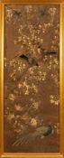 A pair of large Chinese silkwork panels: depicting birds amongst flowering shrubs, worked in creams,