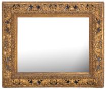 A late 19th Century moulded gilt gesso rectangular mirror:, the plate within a foliate slip,