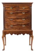 The upper part of a George III mahogany tallboy:, on a later stand, with a moulded dentil cornice,