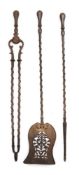A set of three 19th century steel fire irons: with octagonal baluster -shaped handles on spiral