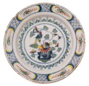 An English delft charger, probably Bristol: painted in red, blue,