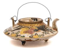 A Japanese Satsuma tripod wine pot and cover: of compressed circular form with lug handles,