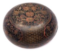 A Chinese black lacquer circular box and cover: incised and decorated with lotus shaped panels of