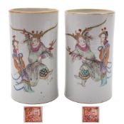 A pair of Chinese famille rose cylindrical vases: each painted with two figures from a scene from