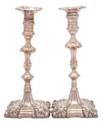 A matched pair of George II/III cast silver candlesticks, maker William Cafe, London,