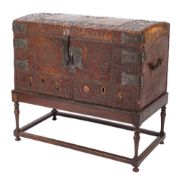 An 18th Century Continental leather covered and steel and brass mounted domed trunk on a later oak