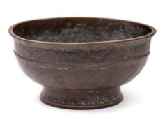 A Chinese bronze footed bowl: the rolled rim with ribbed band and similar below,