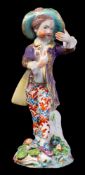 A Bow figure of a 'New Dancer': the youth wearing a green broad-rimmed hat,