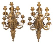 A pair of gilt brass six light wall appliques: the ribbon tied backplates of cartouche-shaped