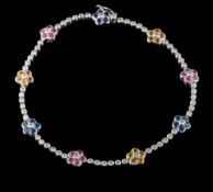 An 18ct white gold, sapphire and diamond bracelet: with floral clusters of pink,