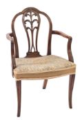 A George III carved mahogany elbow chair:, in the Hepplewhite taste,