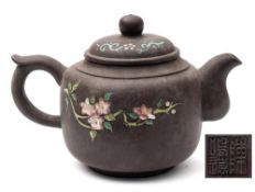 A Chinese Yixing teapot and cover: enamelled with peaches and blossom, potter's seal mark,