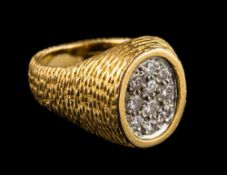 Kutchinsky. An 18ct gold and diamond oval cluster ring: signed 'Kutchinsky'.