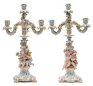 A pair of late 19th century Meissen porcelain four-light figural candelabra: representing the four
