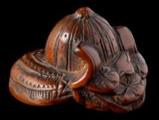 A Japanese carved boxwood netsuke of a kabuto: of traditional design, unsigned, 4cm.