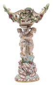 A Meissen porcelain figural comport: modelled with a pair of scantily clad children climbing a