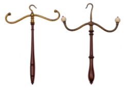 Two late 19th Century gilt brass coat hangers: with turned mahogany handles, each 44cm long.