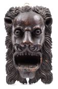 A late 16th Century carved oak lion mask: with flared nostrils, open mouth upper and lower teeth,
