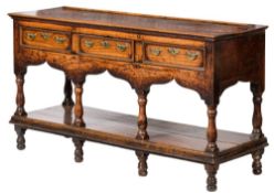 An early 18th Century oak rectangular dresser base:, of small size with a ledge back,