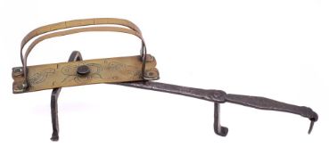 A mid 17th Century wrought iron and brass revolving down-hearth toaster: engraved with confronting