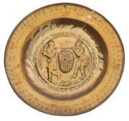 A 16th/early 17th Century Nuremburg brass alms dish: the centre decorated with 'The Spies' Joshua