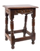A 17th Century oak joint stool: with a rectangular moulded top, gouged frieze and fret cut apron,