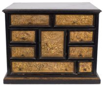 A Continental ebonised and gilded copper table cabinet on a later stand:,