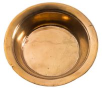 A 17th Century bronze basin: of plain circular form with flared rim, 40.5cm diameter.