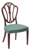 A George III carved mahogany dining chair: the moulded cartouche-shaped back with shaped triple
